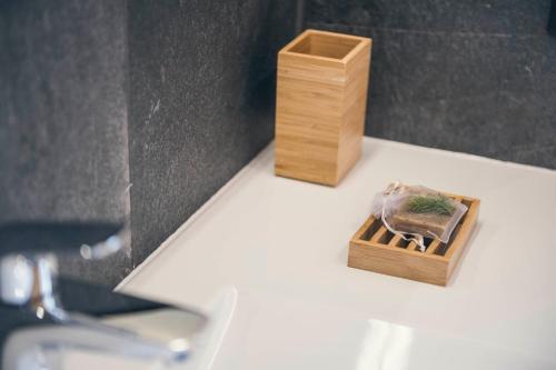 a small wooden box on a counter next to a mirror at Lichtung Woldererhof Wiesenduft in Casateia