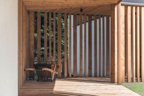 a wooden deck with a chair on it at Lichtung Woldererhof Waldluft in Casateia