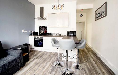 a kitchen and living room with a couch and a table at Mandela House Apartments in Kirkcaldy