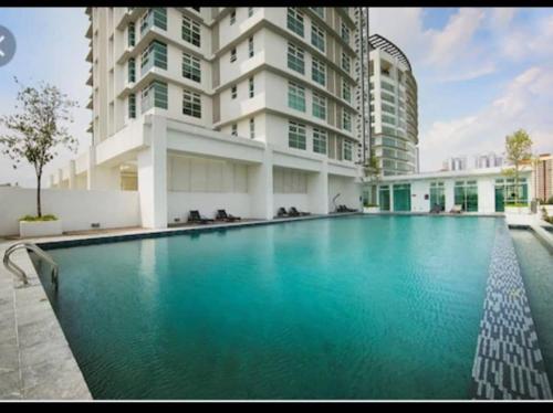 a large swimming pool in front of a building at 3Rooms 2BR SUNWAY NEXIS KOTA DAMANSARA in Petaling Jaya