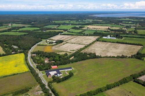 an aerial view of a field with a farm at Gydensgaard ferielejligheder på Læsø in Læsø