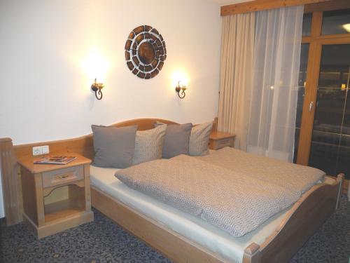 a bedroom with a bed with a table and a window at Piccard Obergurgl in Obergurgl