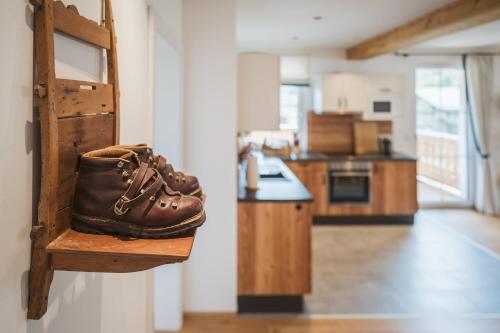 a pair of shoes sitting on a shelf in a kitchen at Ferienwohnungen Villa Salzweg in Bad Goisern