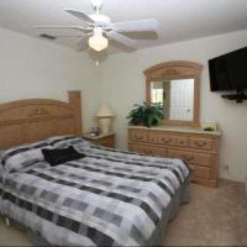a bedroom with a bed and a ceiling fan at Mike & Christine's West Haven Vacation Home in Davenport