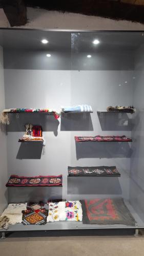 a room with shelves with pillows on them at Tilek Guest House in Sary-Mogul