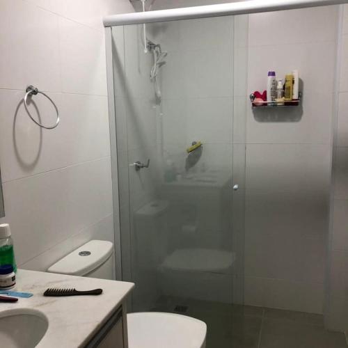 a bathroom with a shower with a toilet and a sink at Recanto Ribas in Ubatuba