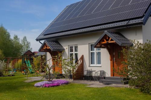 a house with solar panels on the roof at pod lipą in Ustka