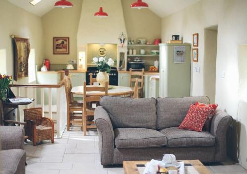 a living room with a couch and a kitchen at Scott's Barn in Cookstown