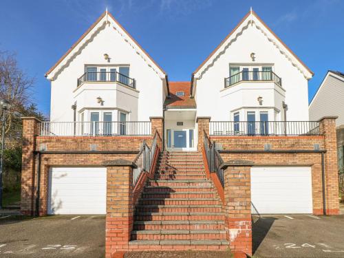 a large white house with two garage doors at Seashells in Tenby