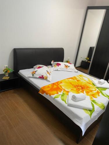 a bedroom with a bed with flowers on it at ANK Summerland Mamaia in Mamaia