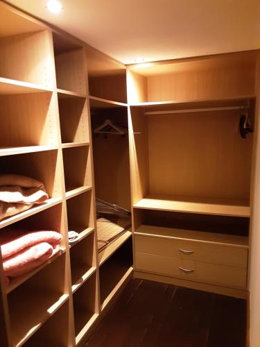 a walk in closet with empty shelves at ’t Wielerpension in Steenhuize-Wijnhuize