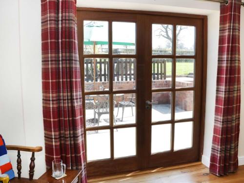 a sliding glass door with a view of a patio at The Cider House in Leominster
