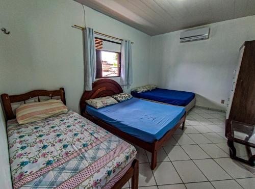 Un pat sau paturi într-o cameră la Casa Em Pirangi Praia - RN
