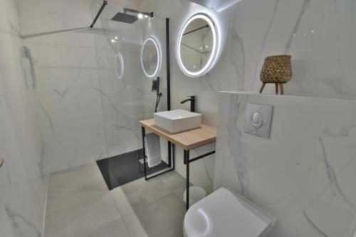 a bathroom with a toilet and a sink and a mirror at Appartement Valras 1ere ligne vue mer in Valras-Plage