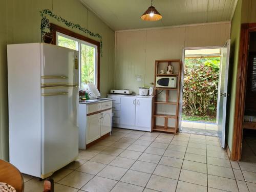 a kitchen with a white refrigerator and a window at Villas Valle Bello in Ujarrás