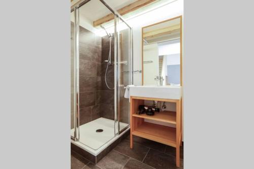 a bathroom with a sink and a shower at Chalet Sonnblick in Stuben am Arlberg