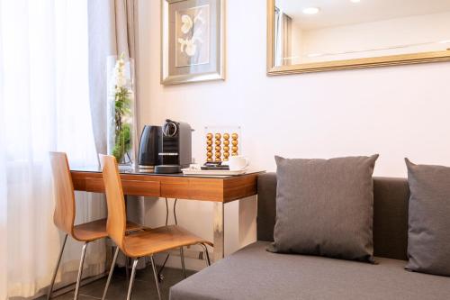 a room with a desk and a couch and a table at City Inn Russell Square in London