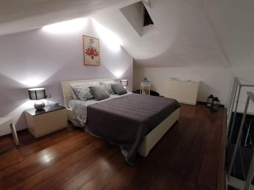 a bedroom with a large bed and a wooden floor at Home Holiday 304 in Iglesias