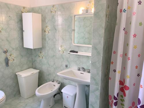 a bathroom with a sink and a toilet and a mirror at Appartamenti Sentiero n1 in Levanto