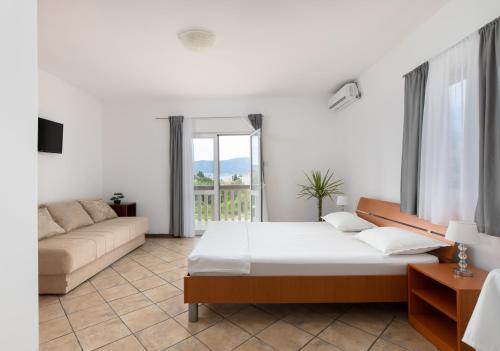 a living room with a bed and a couch at Apartments Bojić in Tivat