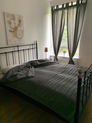 a bedroom with a large bed and a window at Near Ozas in Vilnius