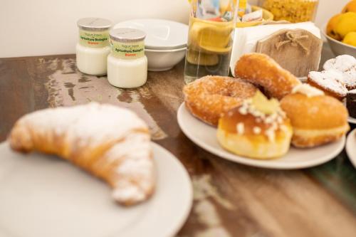 a table topped with plates of donuts and pastries at Ai Tre Mercati in Palermo
