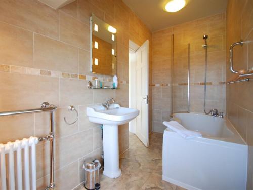 a bathroom with a sink and a shower and a tub and a sink at The Gladstone in Conwy