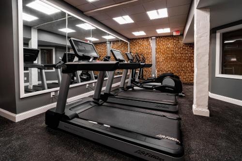 a gym with a row of tread machines in a room at River Street Inn in Savannah