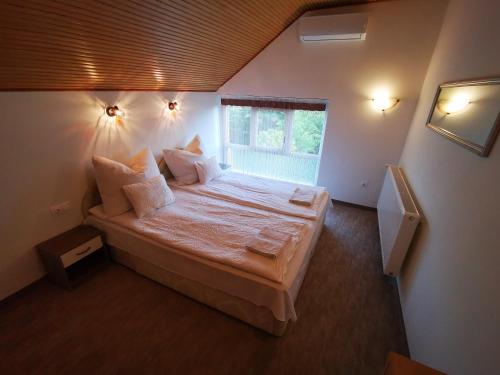a bedroom with a large bed in a room at Máté Holiday House in Gyula