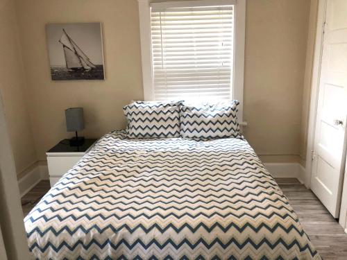a bedroom with a bed with a black and white comforter at Viva San Diego in San Diego