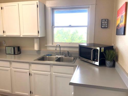 a kitchen with a sink and a microwave at Viva San Diego in San Diego