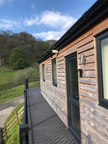 a wooden walkway leading to the door of a log cabin at The Lodge in Llangollen