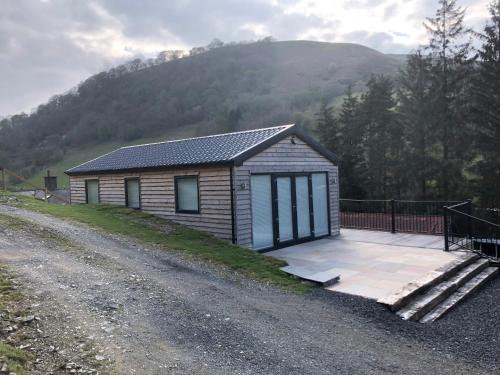a small cabin on the side of a dirt road at The Lodge in Llangollen