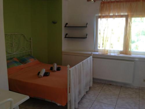 a bedroom with a bed and a window at House with Garden in Nea Peramos