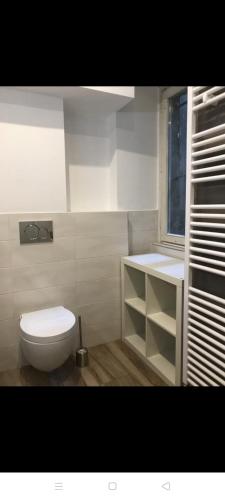 a white bathroom with a toilet and a window at Appartamento il Torchio in Lecco