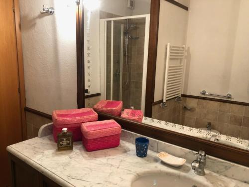 a bathroom with pink towels sitting on a sink at Il Belvedere - Cannelle beach Argentario - Tuscany in Monte Argentario