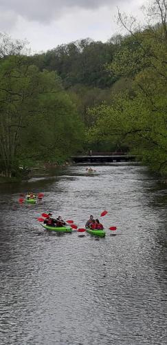 a group of people in kayaks on a river at Le Petit Renard in Durbuy
