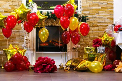 a group of red and gold balloons in front of a fireplace at Aristokrat in Vinnytsya