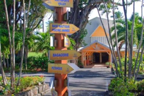 a street sign with arrows pointing in different directions at Studio La Valentina face à la marina in Les Trois-Îlets
