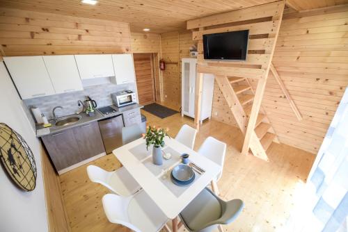 a kitchen and dining room of a tiny house at Pokoje Amelia in Zator