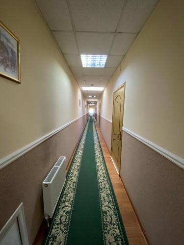 an empty hallway with a green aisle in a building at Ковчег in Chernivtsi