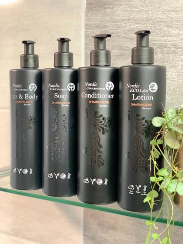 a group of four black bottles on a shelf at Ludvika Stadshotell in Ludvika