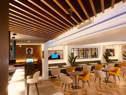 a restaurant with tables and chairs in a building at Holiday Inn Naples by IHG in Naples