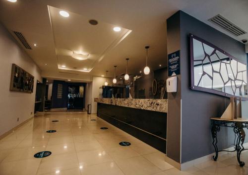 a lobby of a restaurant with a counter at Hotel Calafia in Mexicali