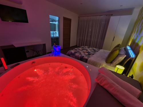 a red bath tub in a room with a bed at B&B Artemide in Agropoli