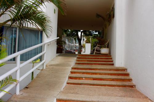 a stairway leading up to a building with a bunch of stairs at Hotel y Suites Corita in Bucerías