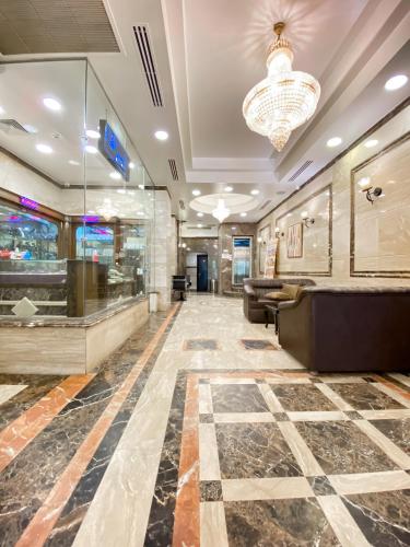 a lobby of a hotel with a chandelier at Best View Pyramids Hotel in Cairo