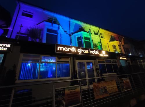 a large building with a sign on the side of it at Mardi Gras Hotel in Blackpool