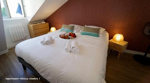 a bedroom with a bed with a bowl of fruit on it at Appartements de caractère centre in Vannes