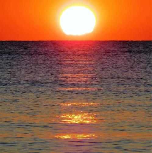 a sunset over the ocean with the sun setting at Hotel B&B Rispescia Grosseto in Rispescia